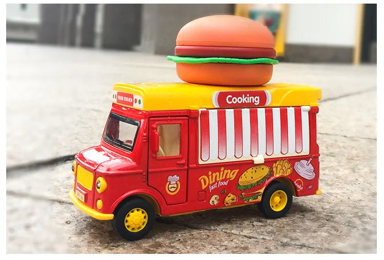 A red and yellow toy food truck shaped like a burger, featuring a large burger on top.