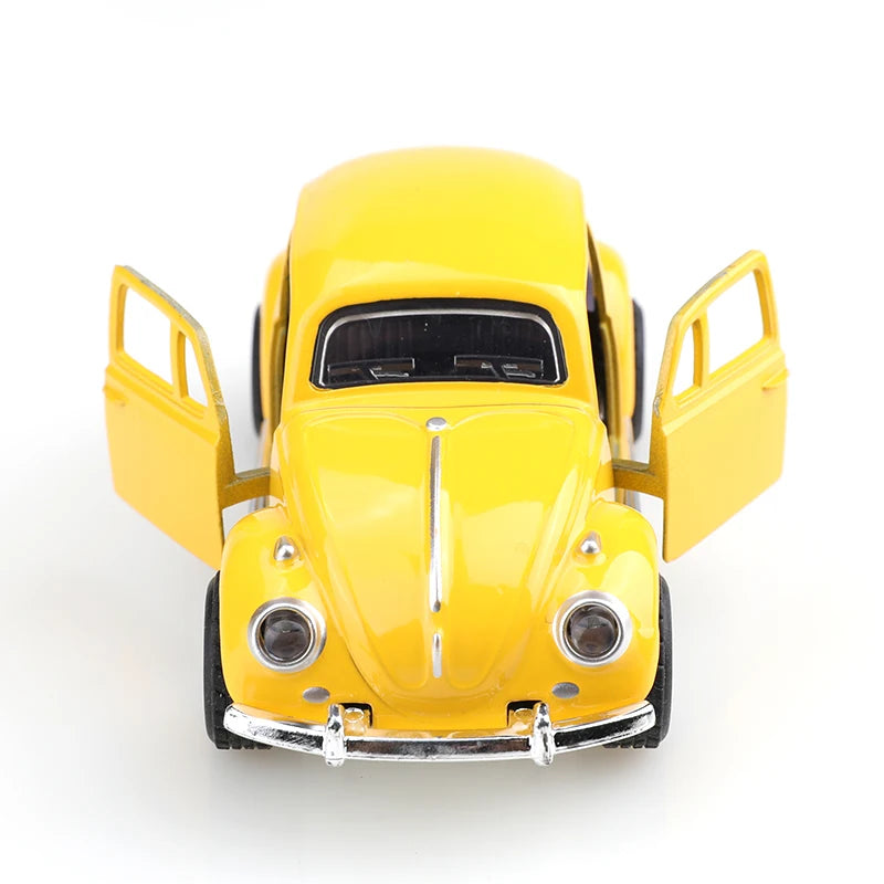 A yellow 1:38 die-cast model of a classic Beetle car viewed from the front.