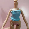 A fashion doll in a light blue top and pink panties is displayed against a pink background.