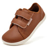 A brown kids barefoot sneaker with double hook-and-loop straps shown from the side.