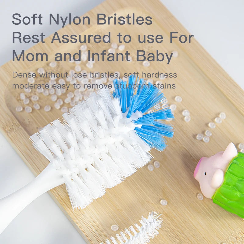 A white nylon bristled brush set for cleaning baby bottles is shown on a wooden board.