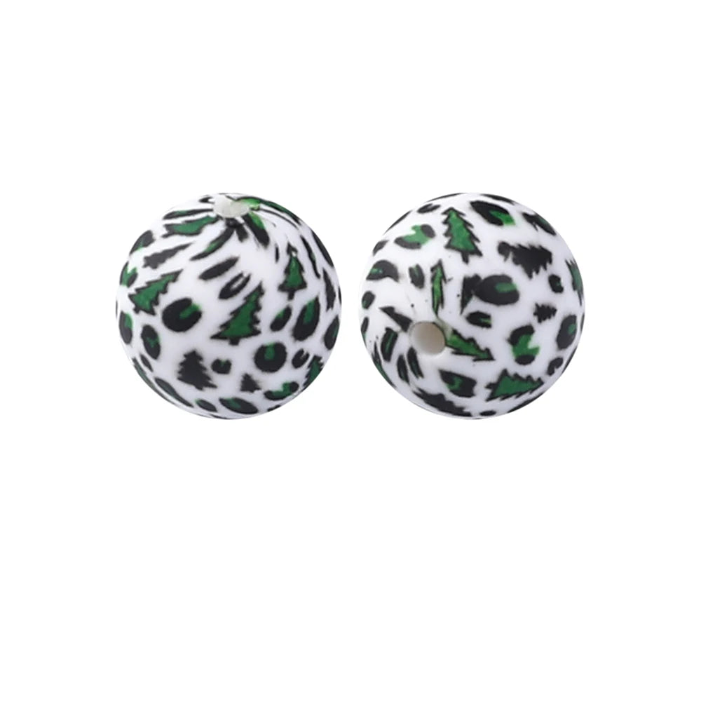 A pair of round, black and green leopard print silicone beads for jewelry making
