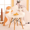 A plush cat pillow resembling a tiger is sitting next to a gray cat pillow on a white table.