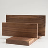 A rectangular board of dark brown black walnut wood used for engraving and DIY projects.