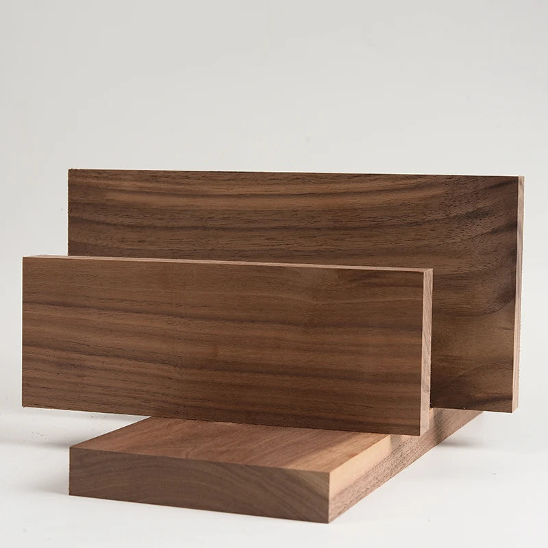 A rectangular board of dark brown black walnut wood used for engraving and DIY projects.