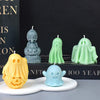 A collection of silicone ghost molds in various shades of green and yellow displayed on a dark surface.
