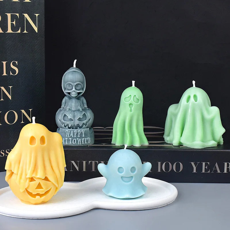 A collection of silicone ghost molds in various shades of green and yellow displayed on a dark surface.