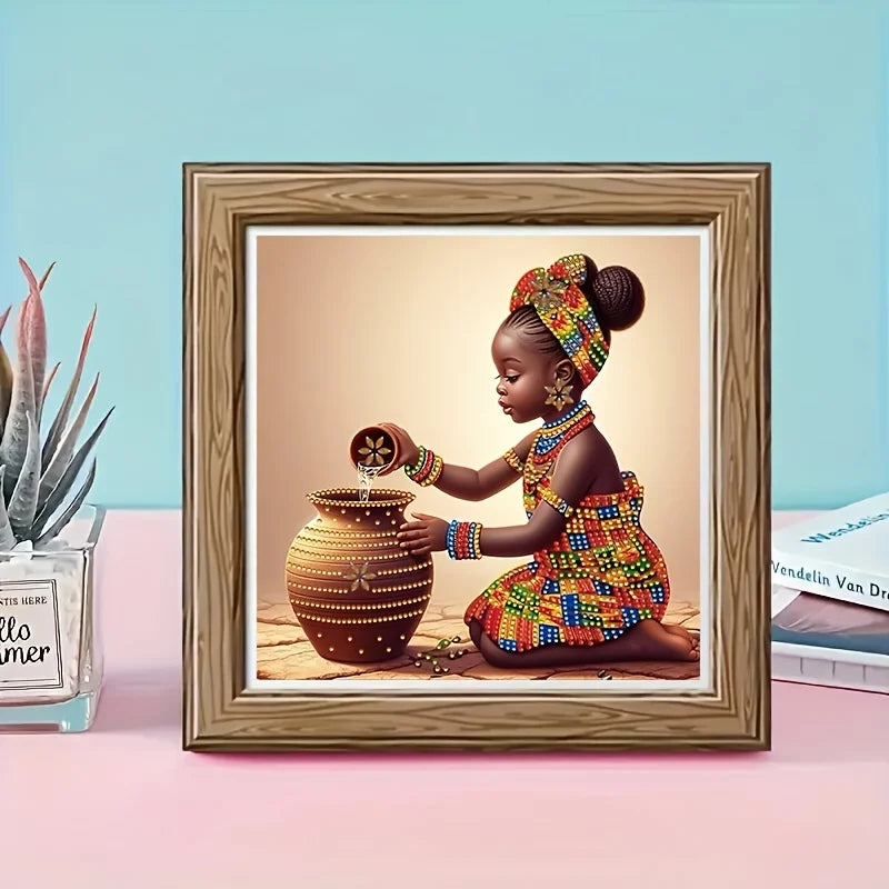 A framed picture of a young African girl wearing beaded jewelry and colorful clothing next to a ceramic jar.