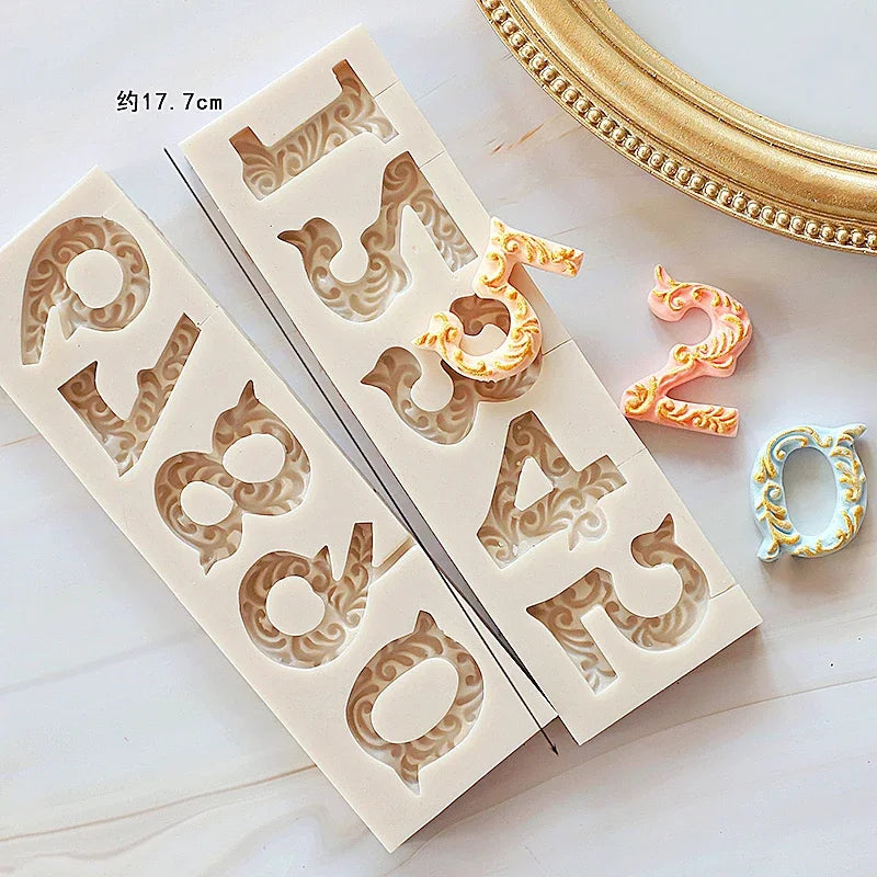 A set of silicone baby-themed cake molds featuring letters and decorative elements for crafting.