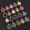 A collection of gold-plated water droplet charms featuring various colored crystal rhinestones and flowers.