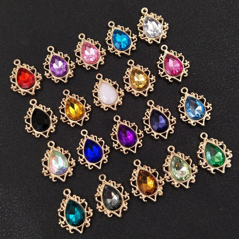 A collection of gold-plated water droplet charms featuring various colored crystal rhinestones and flowers.