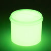A clear container of glow-in-the-dark crystal slime emitting a bright green light.