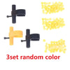 A set of three random color finger ring launcher keychains with black and yellow components.