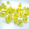A cluster of faceted yellow glass bicone beads for jewelry making
