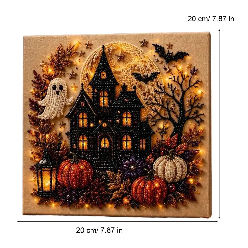 A framed piece of art depicting a spooky Halloween scene with a black house, bats, pumpkins, and glowing lights.