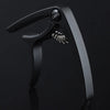A black aluminum alloy quick-change guitar capo with a visible spring mechanism.