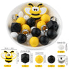 A white bowl filled with yellow and black silicone beads shaped like cartoon bees for DIY jewelry making