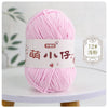 A ball of pink chenille yarn labeled in Chinese characters for knitting and crochet