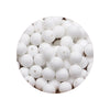 A close-up view of a pile of white silicone beads for DIY jewelry making.