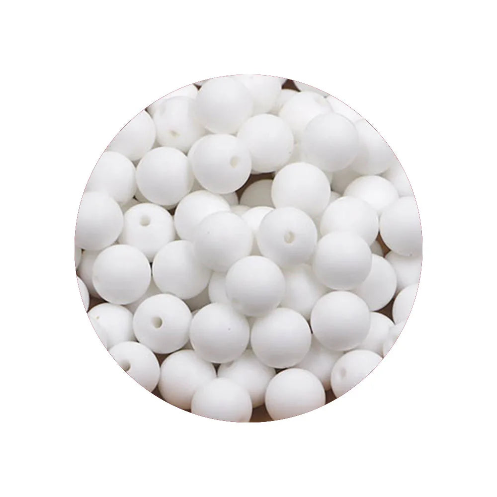 A close-up view of a pile of white silicone beads for DIY jewelry making.