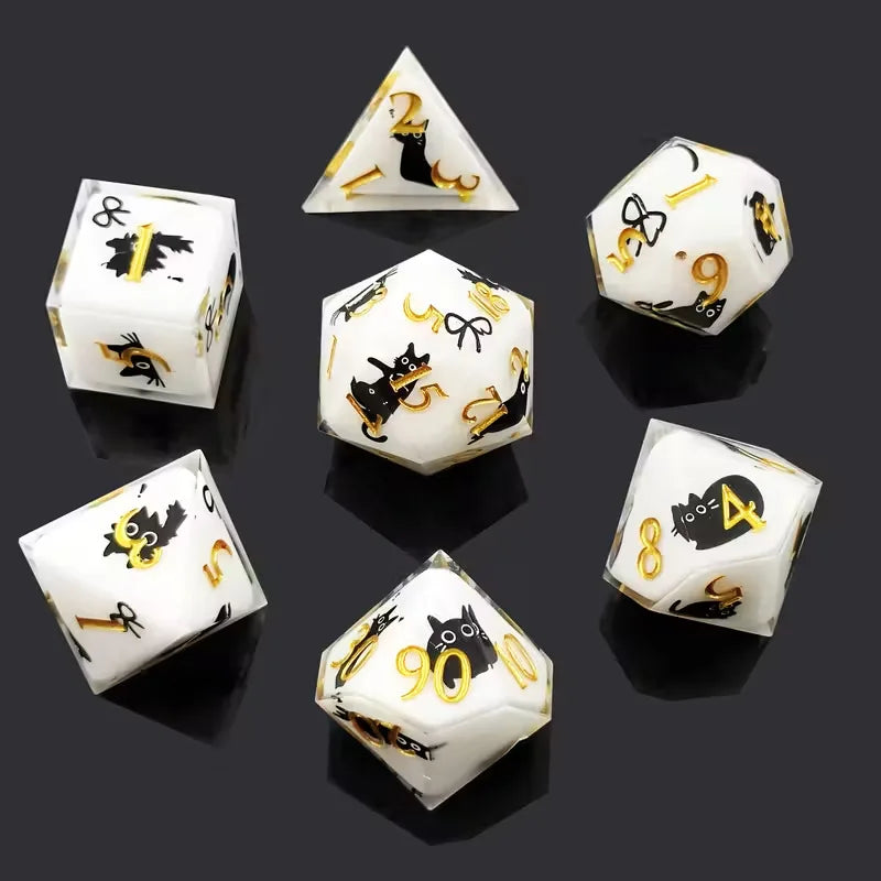 A set of milk white resin dice featuring a black kitten design, shown from various angles.