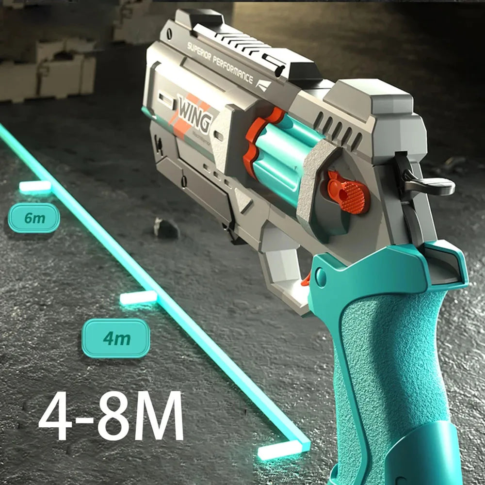 A close-up of a gray and teal foam bullet toy pistol with a rapid-fire action mechanism, shown in a side view.