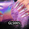 A hand displays long nails coated with iridescent holographic rainbow nail glitter dust.
