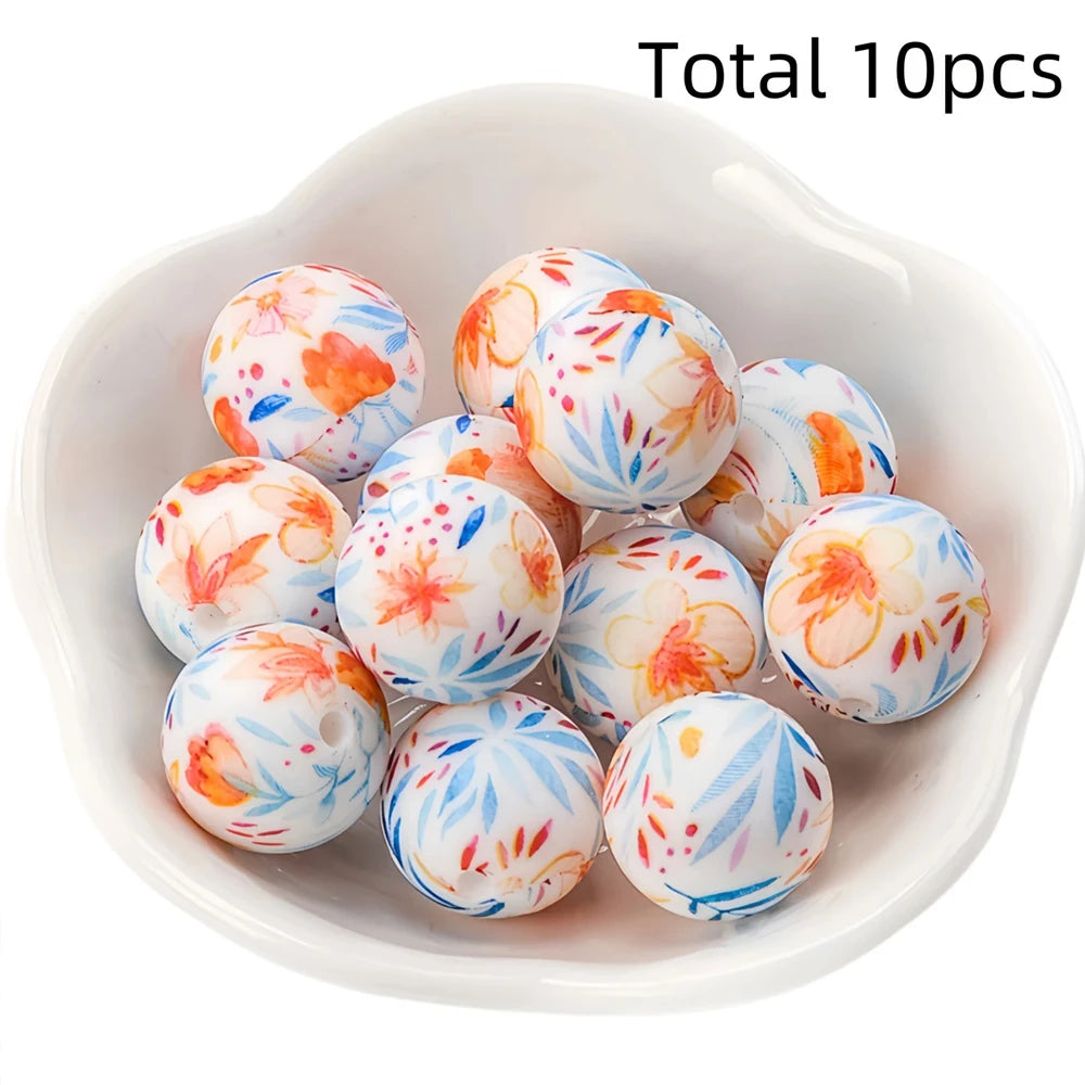 A bowl filled with ten colorful printed silicone beads for DIY jewelry making