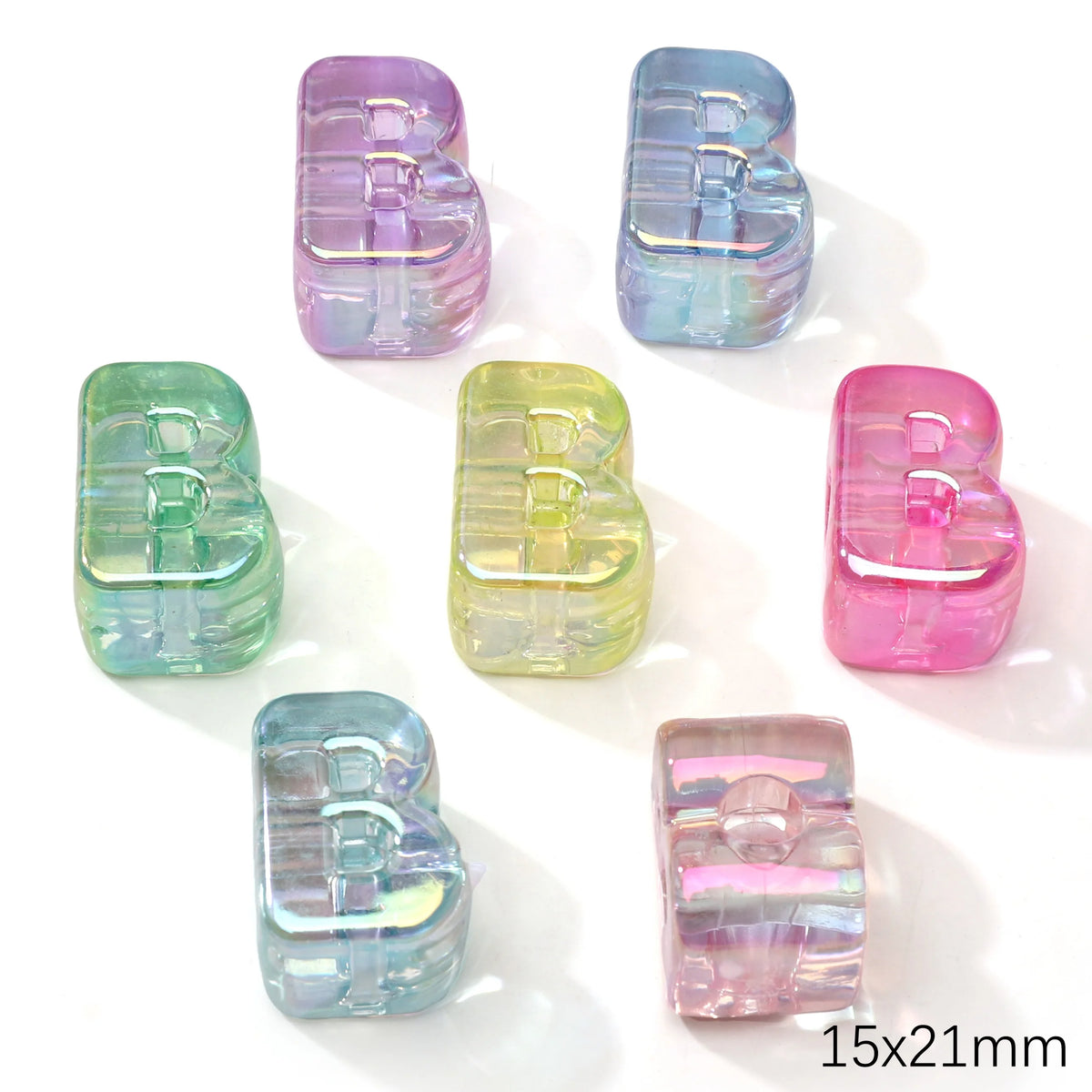 A collection of colorful acrylic alphabet beads in various shades of purple, blue, and pink.