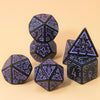 A set of seven polyhedral dice in black and purple on a light background.