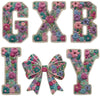 Floral letter patches in various shades of pink, purple, and green with bow accents for DIY clothing