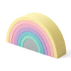A rainbow-shaped silicone toy with pastel colored arches, including pink, purple, blue, and gray.