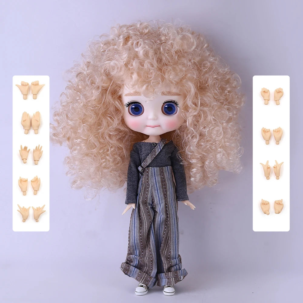 A light blonde curly hair fashion doll with blue eyes and a dark gray outfit, shown with accessories.