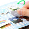 A finger is placing a gray cat sticker onto an interactive learning book featuring various weather-themed stickers like snowy
