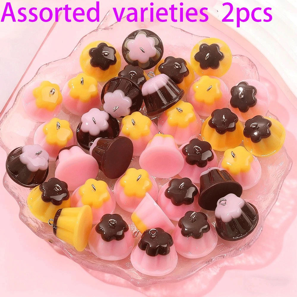 Assorted varieties of pudding-shaped resin pendants for DIY jewelry making in yellow, pink, and dark brown colors