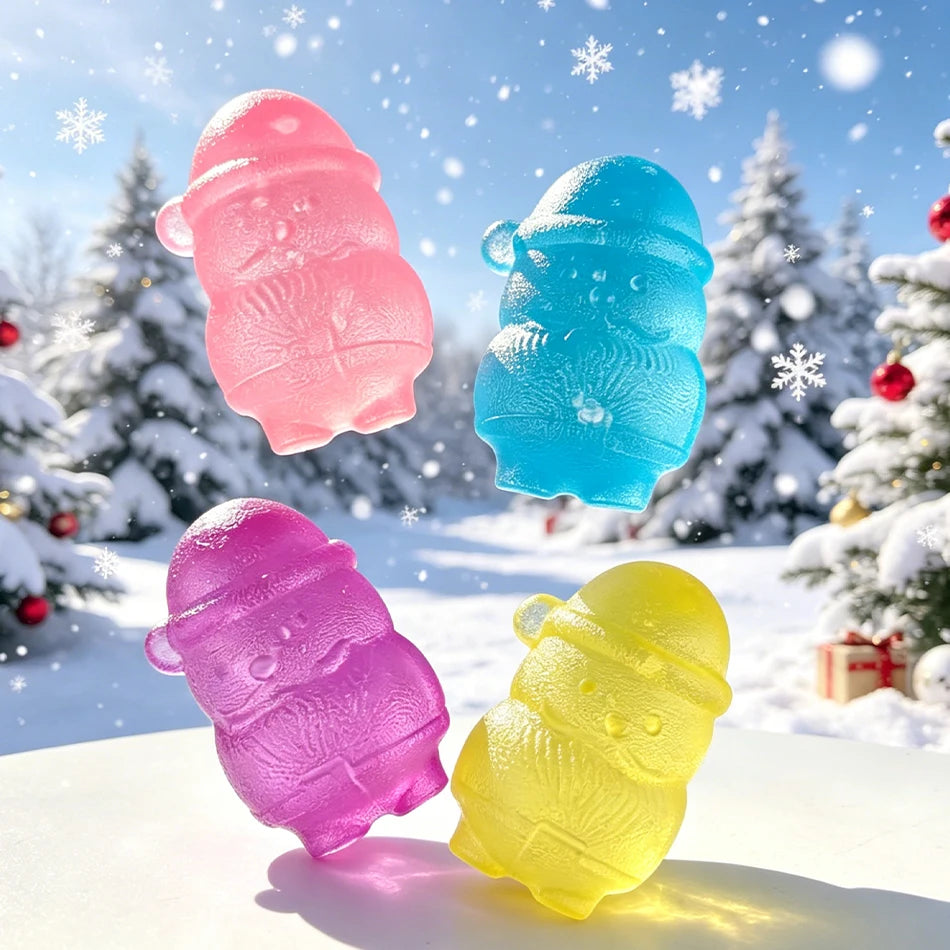 Three squishy toys shaped like snowmen in pink, blue, and purple colors resting on a white surface with a snowy background.