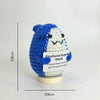 A handwoven crochet shark ornament featuring blue and white colors, used as desk decor.