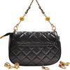 Black quilted leather bag with gold metal D-ring buckle clips hanging from the strap