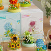 A collection of DIY flower bouquet building blocks in various colors and shapes displayed on a wooden surface.