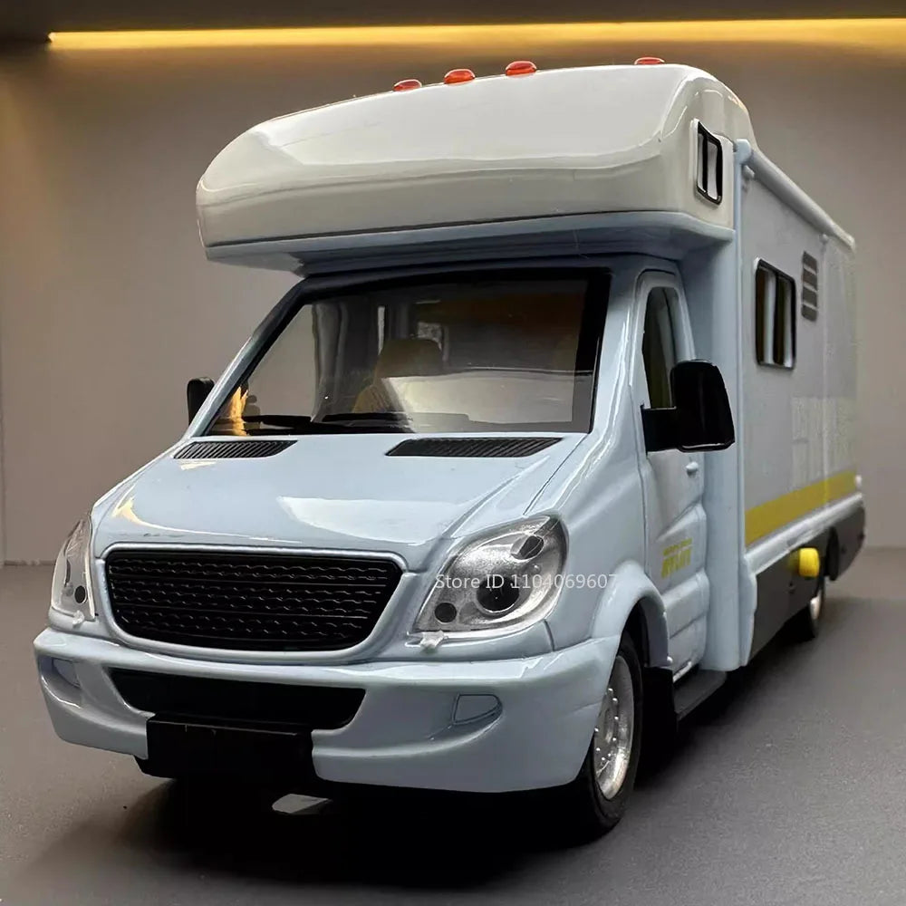 A white 1:32 scale diecast camping RV with sound and light effects parked indoors.
