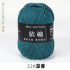 A ball of teal milk cotton yarn labeled with Chinese characters and the number 33, ready for knitting or crochet.