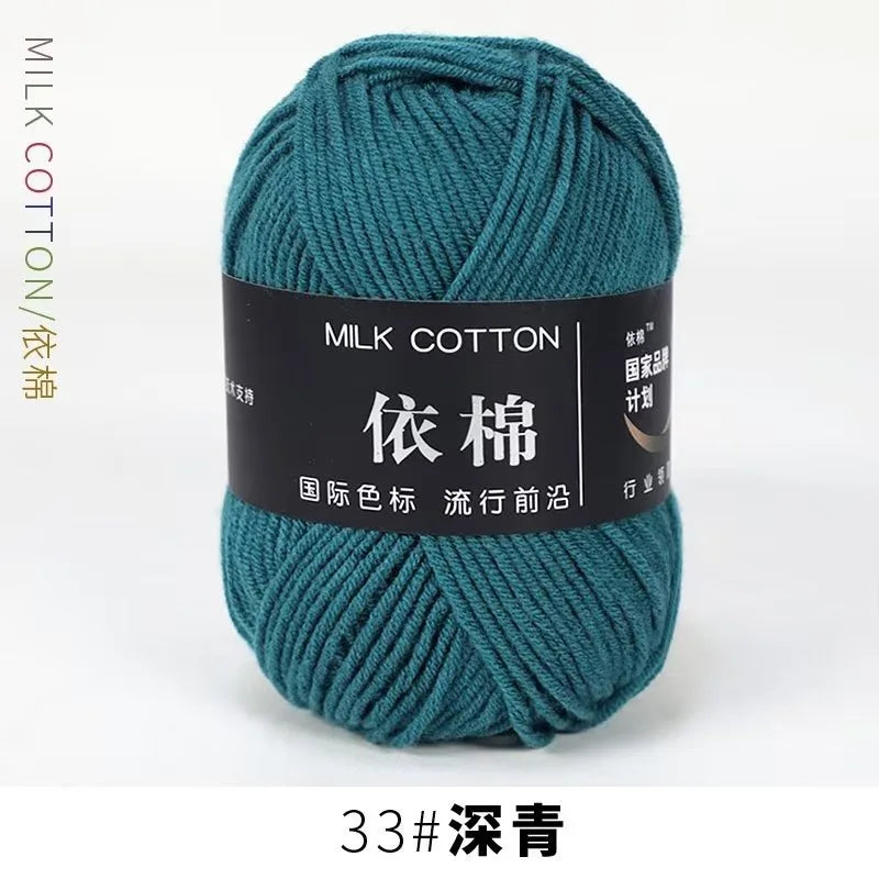 A ball of teal milk cotton yarn labeled with Chinese characters and the number 33, ready for knitting or crochet.