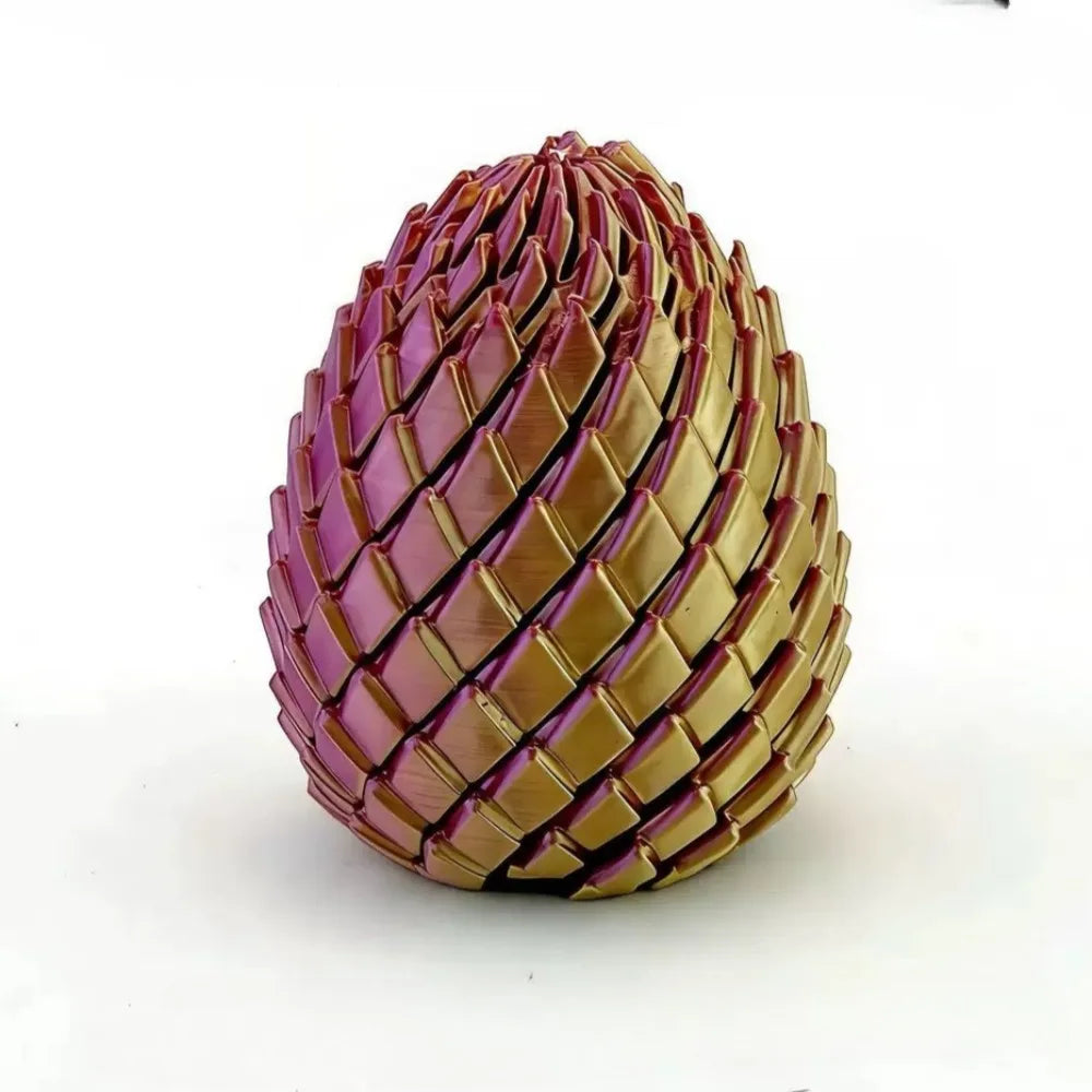 Textiles, eiförmiges Fidget-Spielzeug aus rosa und goldfarbenem Kunststoff.
