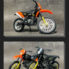 A diecast model of a KTM 450 SX-F motorcycle in black and orange colors.
