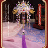A detailed 3D metal phoenix crown model kit with colorful jewels and feathers displayed on a velvet cloth.