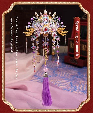 A detailed 3D metal phoenix crown model kit with colorful jewels and feathers displayed on a velvet cloth.
