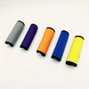 Five colored neoprene luggage handle covers in gray, purple, orange, blue, and yellow laid out on a white surface.