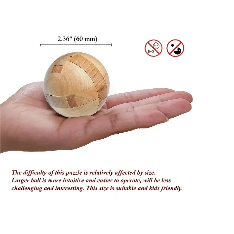 A wooden brain teaser puzzle ball is held in a hand, demonstrating its size and texture.