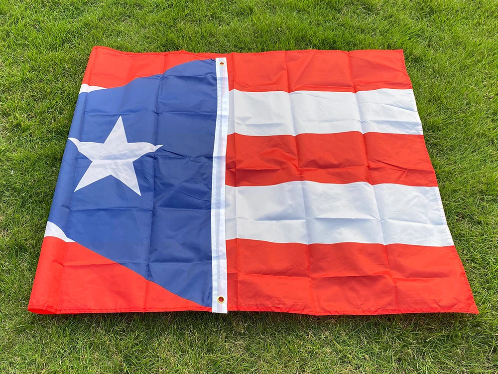 A large, red and blue Puerto Rico national flag banner displayed outdoors on green grass.