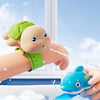 A cute, multi-functional pop ruler shaped like a turtle or dolphin is being used to spray water in a bathtub.